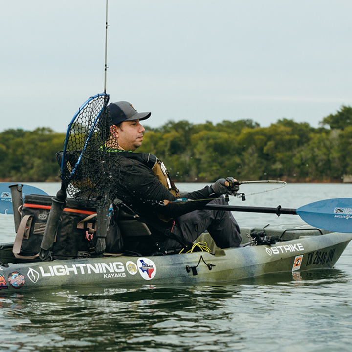 angler drift snap button tidal blue across angler's lap while casting