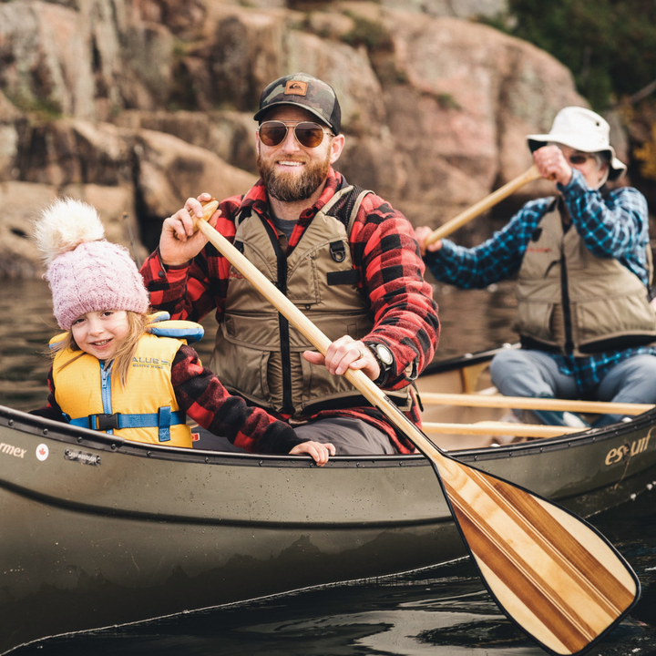Expedition Plus wooden canoe paddle paddled by the bow. Older woman paddling stern and young girl sitting in the front.
