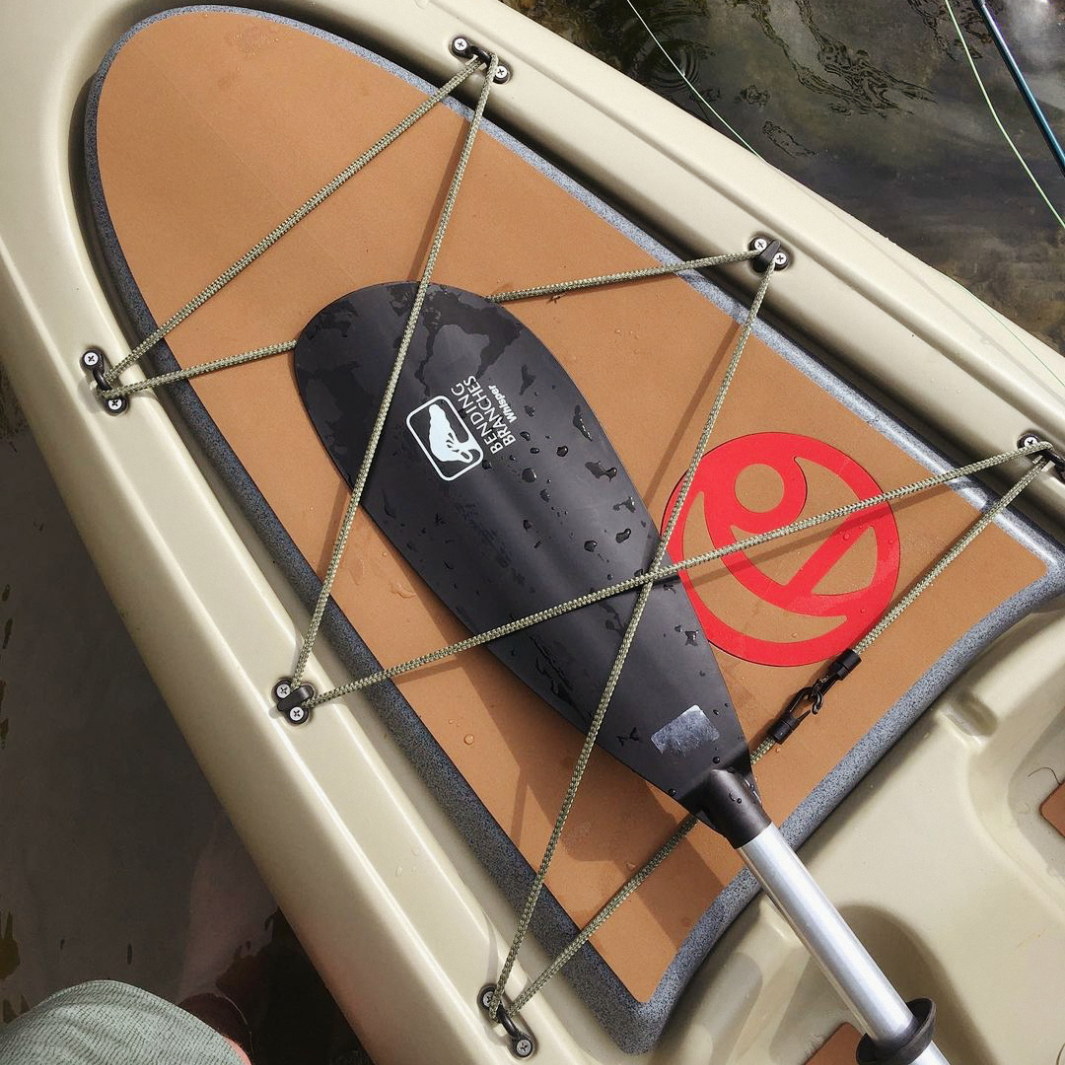 Whisper strapped in a kayak's front bungies 